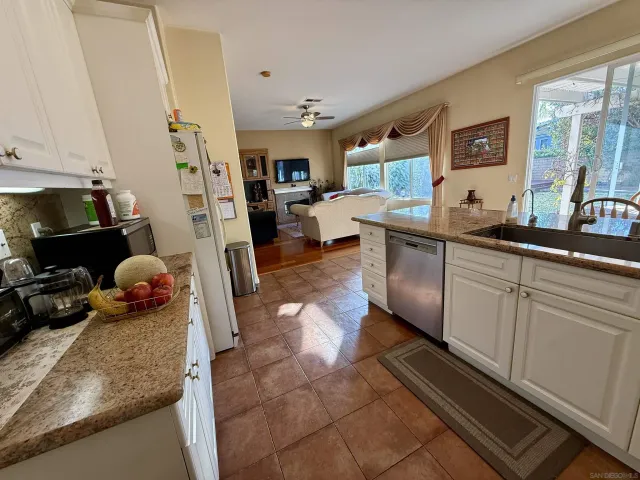 a kitchen with stainless steel appliances granite countertop a sink and cabinets