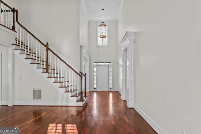 a view of entryway and hall with wooden floor