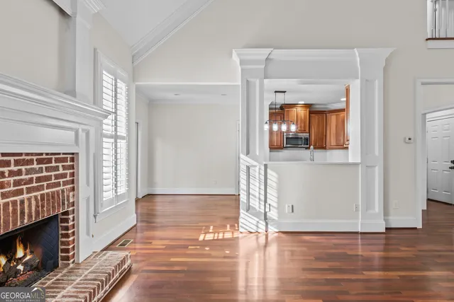 a view of a livingroom with wooden floor and a fireplace