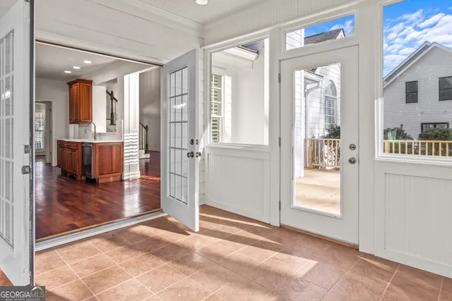 a view of a hallway with bathroom and glass door