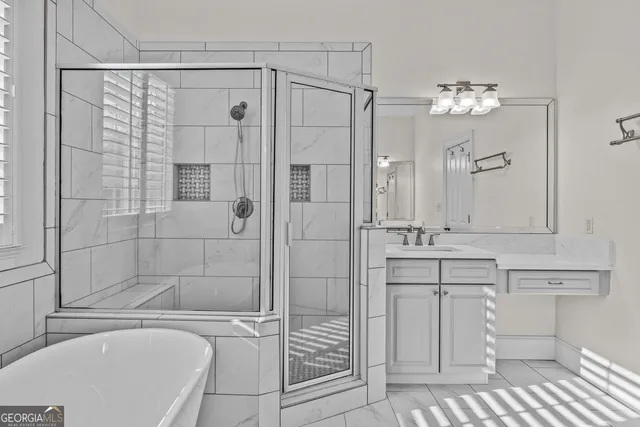 a bathroom with a bathtub shower sink and mirror