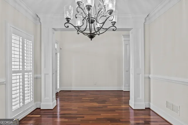 a view of a room with wooden floor and door
