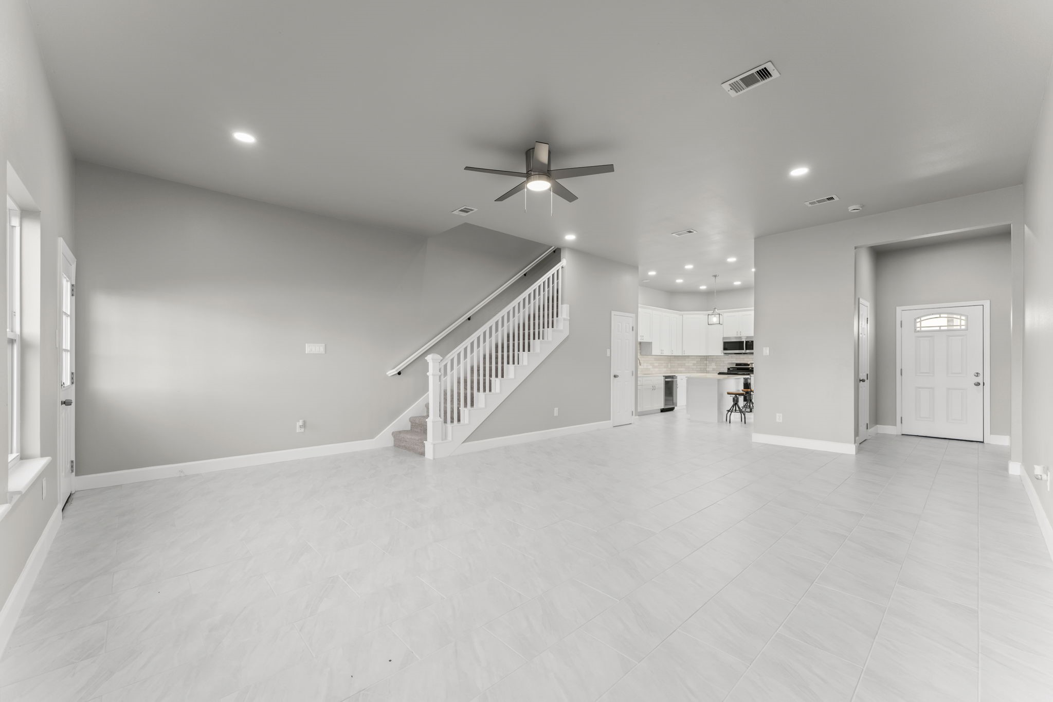 8153 Crestview Drive Houston, TX 77028 - Photo 6 of 27 an empty room with staircase and a ceiling fan