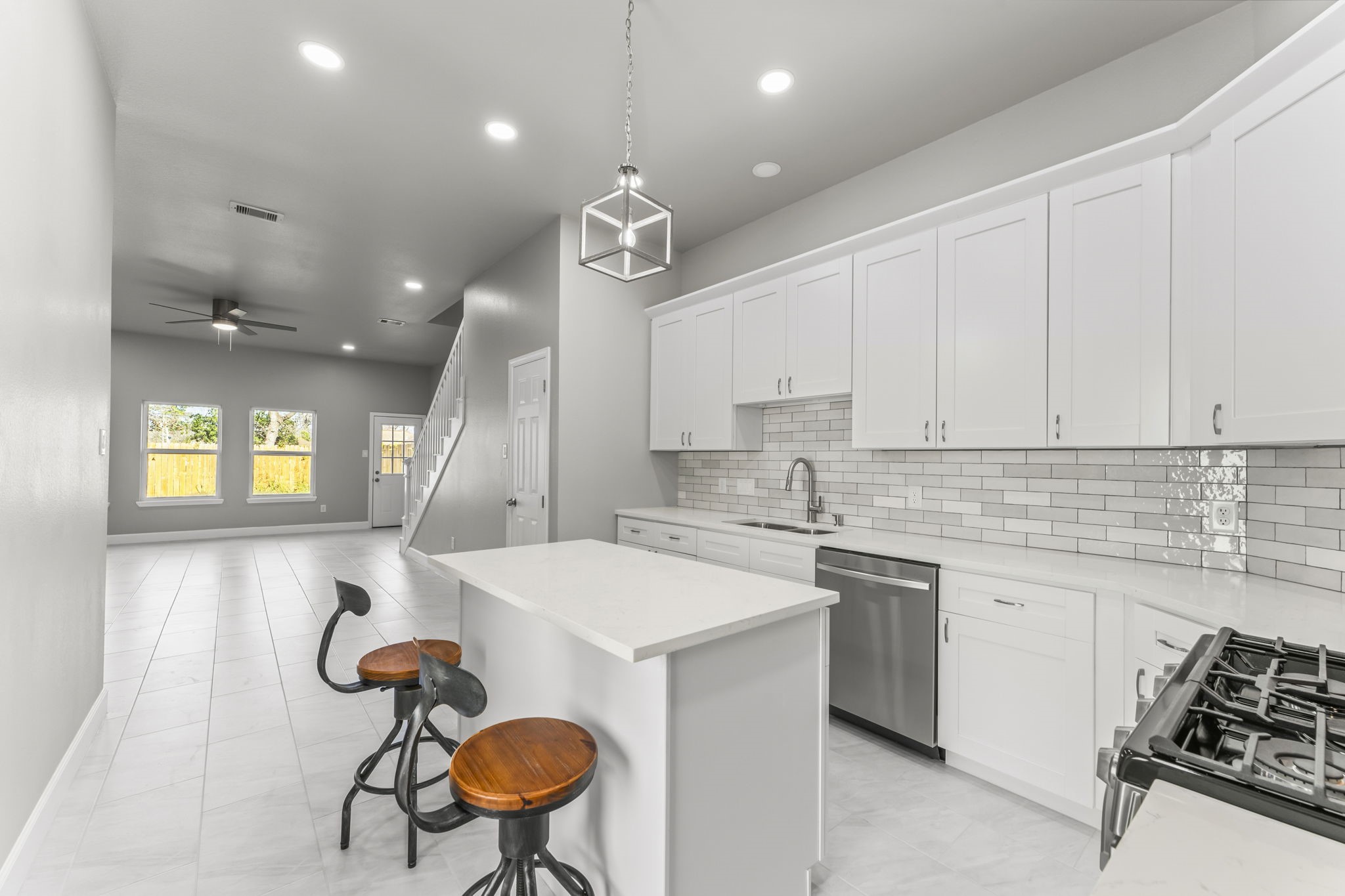 8153 Crestview Drive Houston, TX 77028 - Photo 10 of 27 a kitchen with stainless steel appliances kitchen island a table chairs in it and wooden floors
