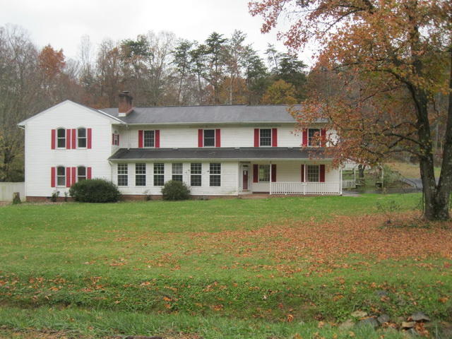 1261 Mountain Pass Road Blue Ridge, VA 24064 - Photo 1 of 23 a front view of a house with a garden