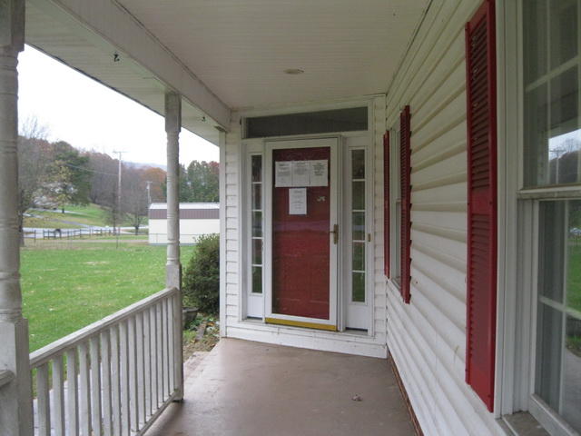 1261 Mountain Pass Road Blue Ridge, VA 24064 - Photo 5 of 23 a view of a porch with a big yard and floor to ceiling window