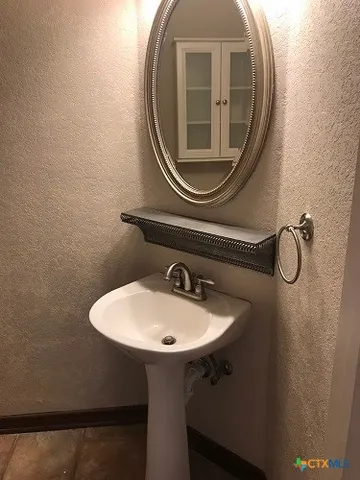 a white toilet sitting next to a small window