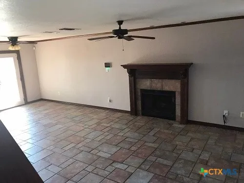 a view of an empty room with a fireplace