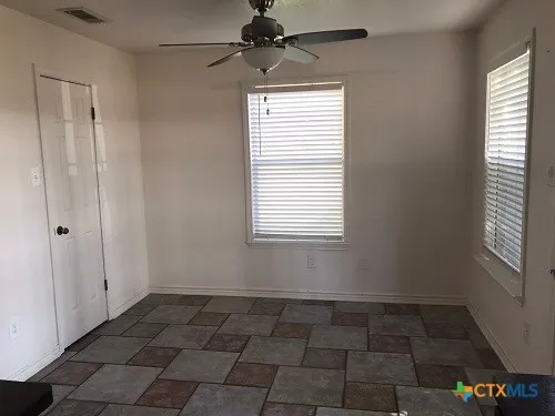 a view of an empty room with a window