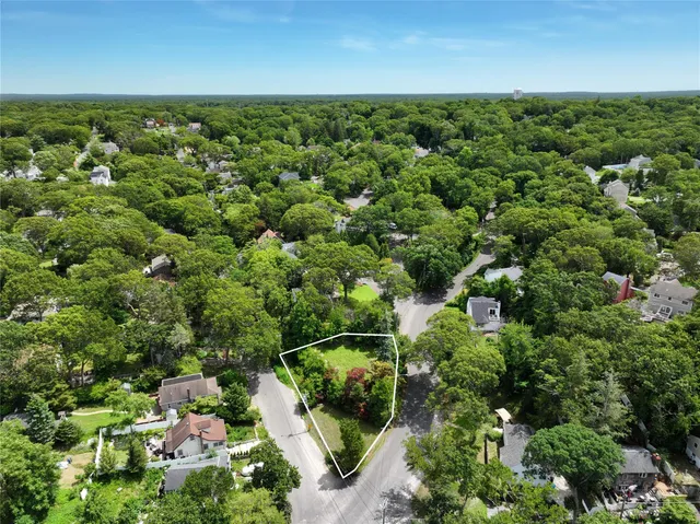 an aerial view of a houses with yard