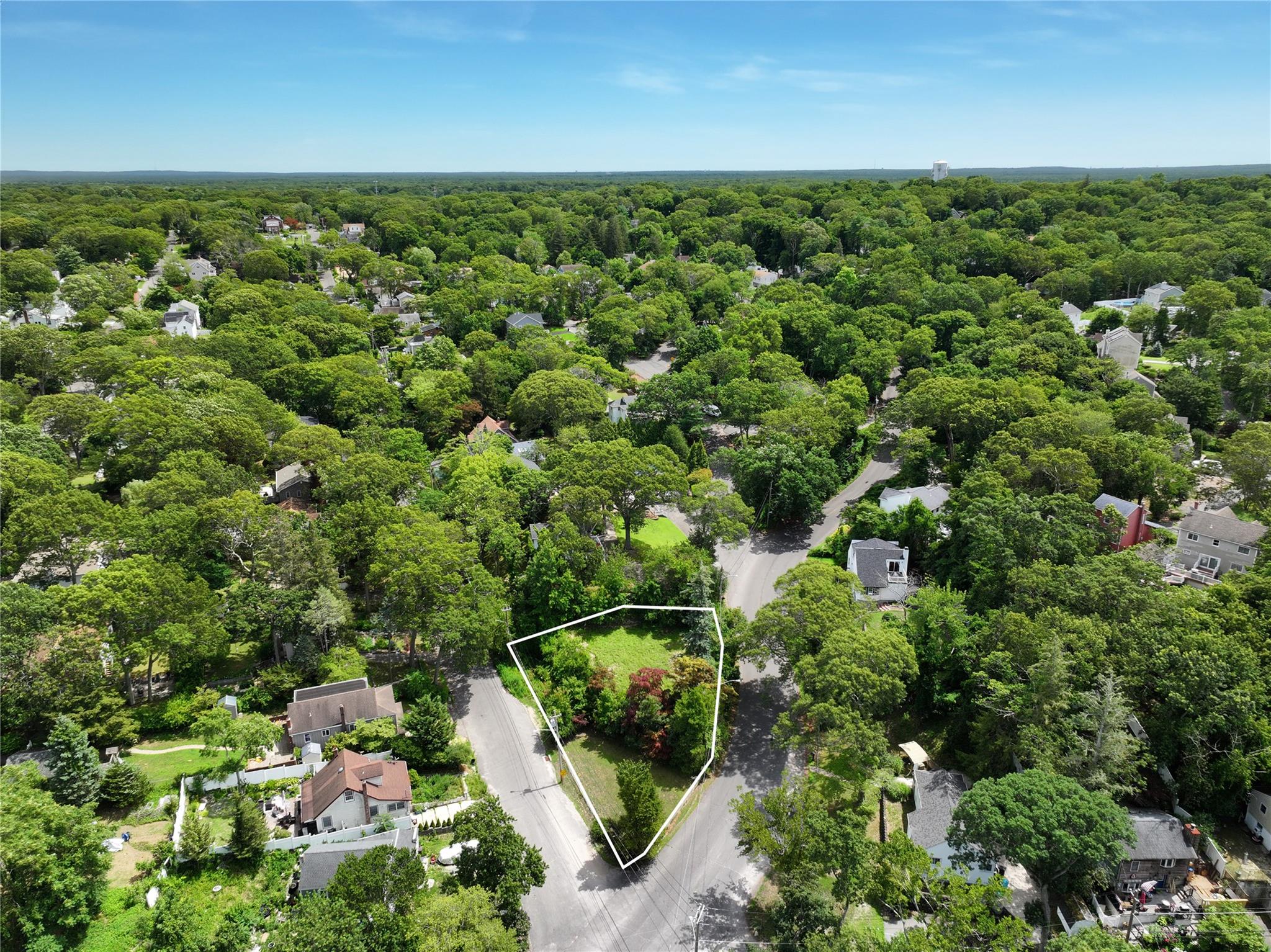 an aerial view of a houses with yard