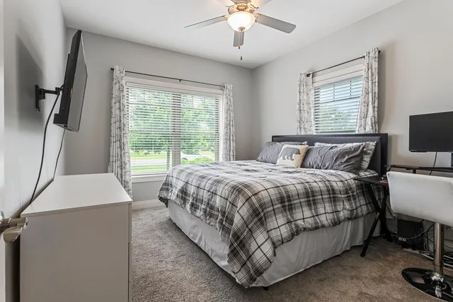 a bed sitting in a bedroom next to a window