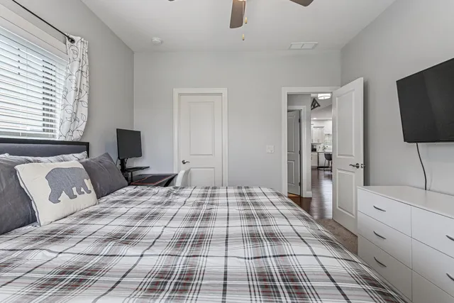 a bedroom with a large bed and a flat screen tv