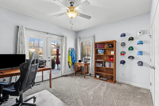 a view of a livingroom with workspace and a window