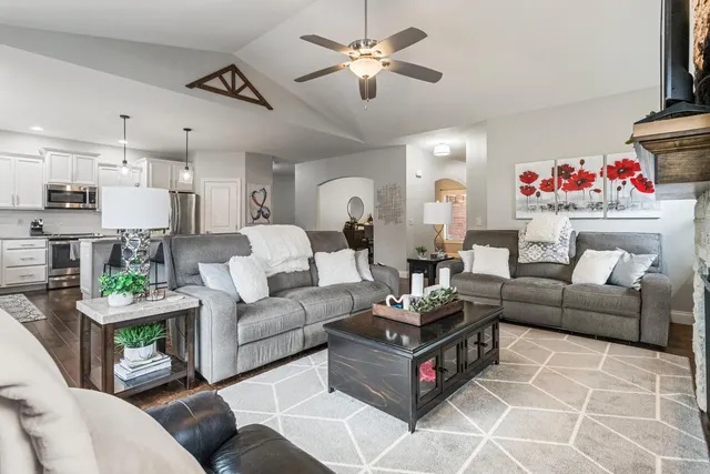 a living room with furniture and a chandelier