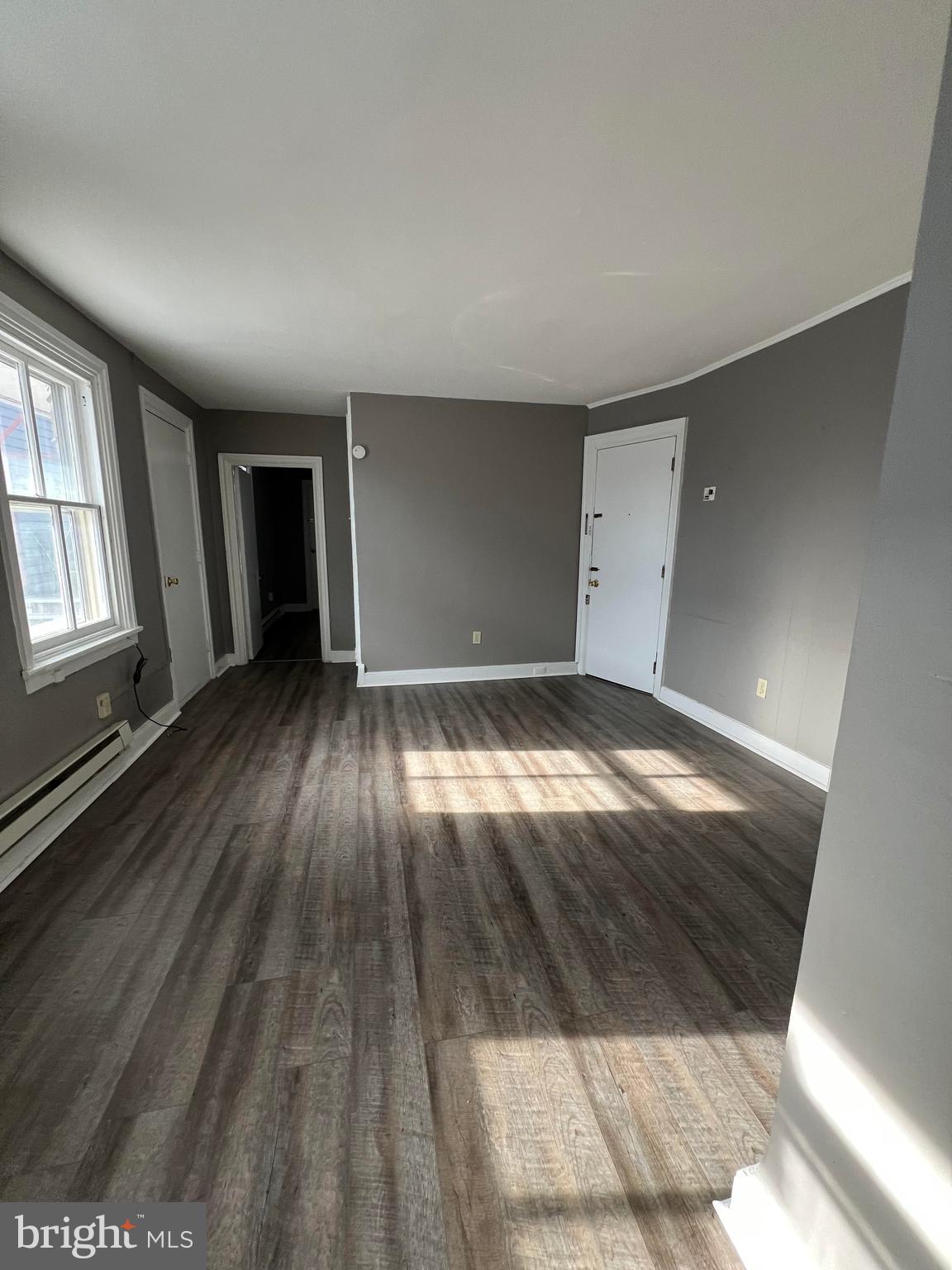 155 North Hanover Street Carlisle, PA 17013 - Photo 14 of 16 an empty room with wooden floor and windows