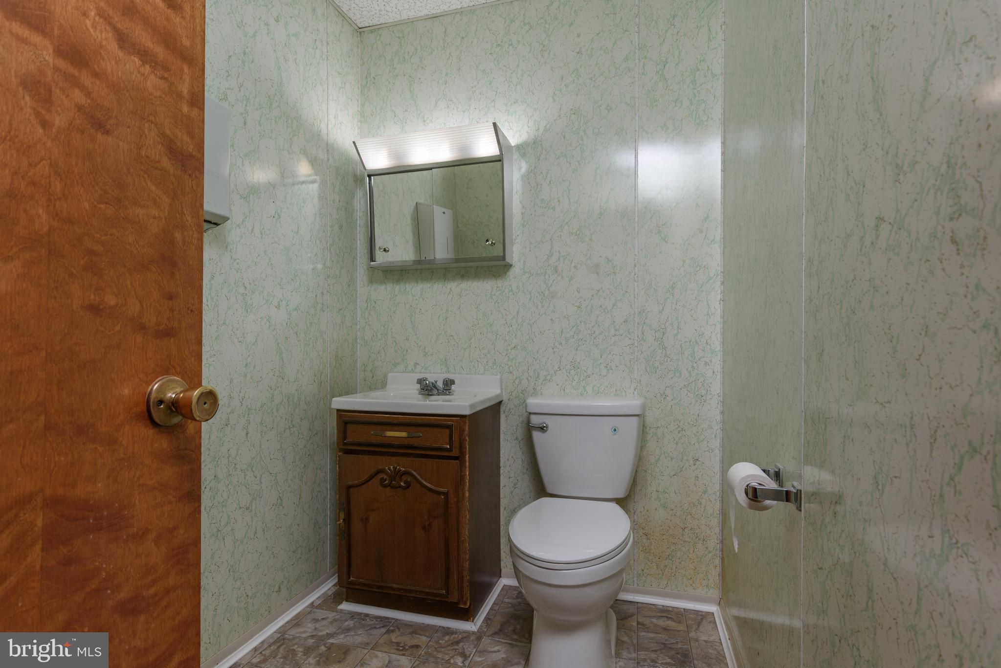155 North Hanover Street Carlisle, PA 17013 - Photo 7 of 16 a bathroom with a toilet a sink and mirror