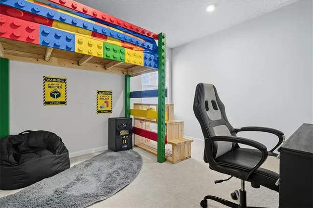 a bedroom with a bed a desk and chair