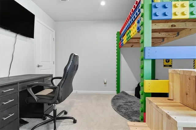 a view of a workspace with furniture and a flat screen tv