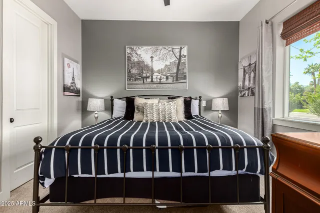 a bedroom with a bed and a view of kitchen