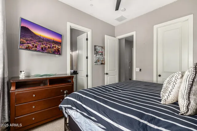 a bedroom with a bed and a painting