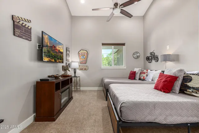 a spacious bedroom with a bed and a painting on the wall