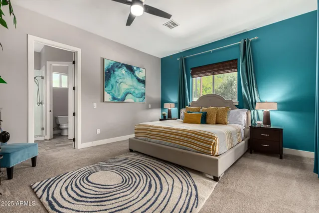 a bedroom with a bed and a chandelier