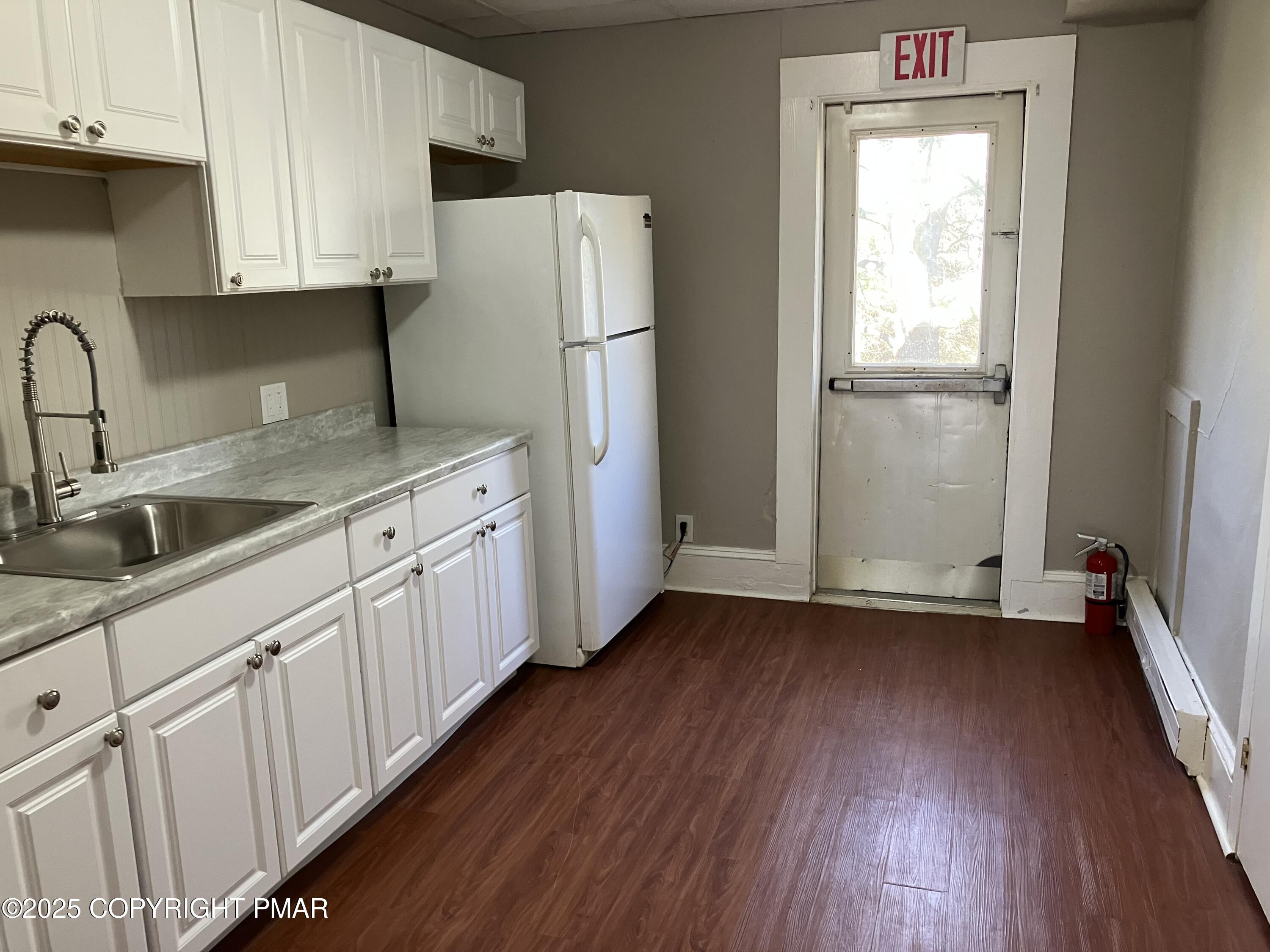 383 Old Rte 940, Unit 301 Pocono Pines, PA 18350 - Photo 2 of 10 a kitchen with a sink a refrigerator and cabinets