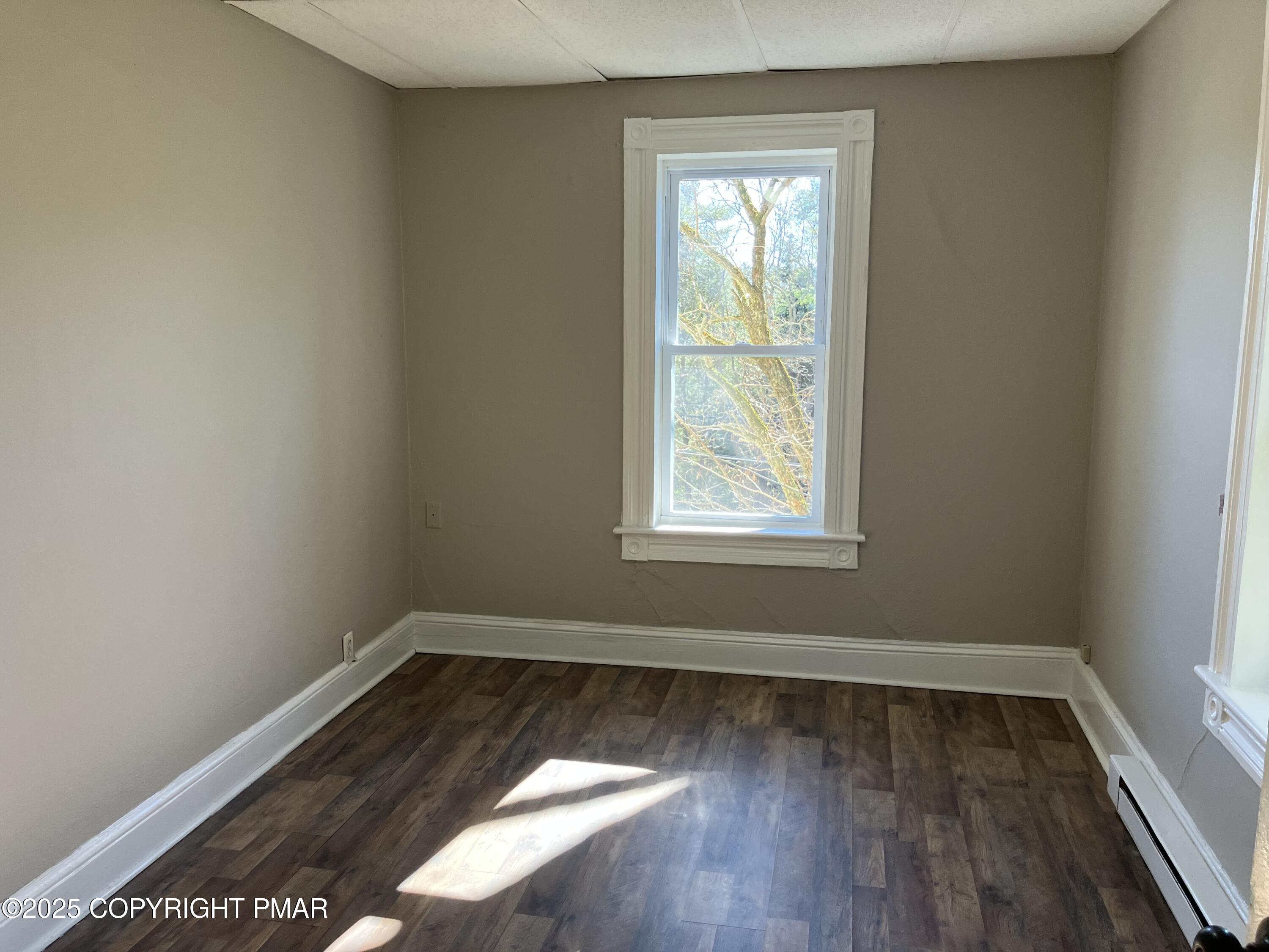 383 Old Rte 940, Unit 301 Pocono Pines, PA 18350 - Photo 3 of 10 an empty room with wooden floor and windows