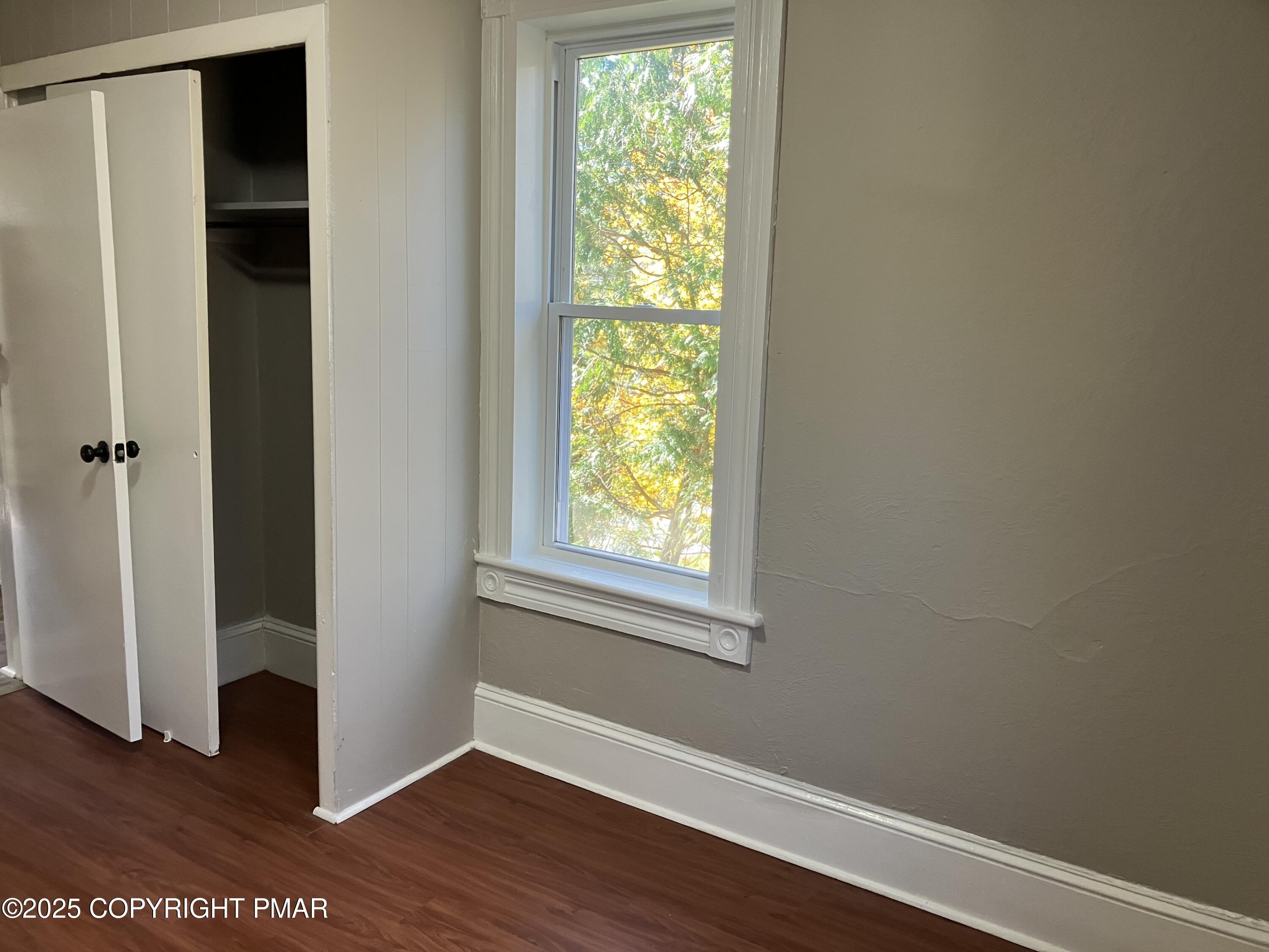 383 Old Rte 940, Unit 301 Pocono Pines, PA 18350 - Photo 6 of 10 a view of an empty room with wooden floor and a window