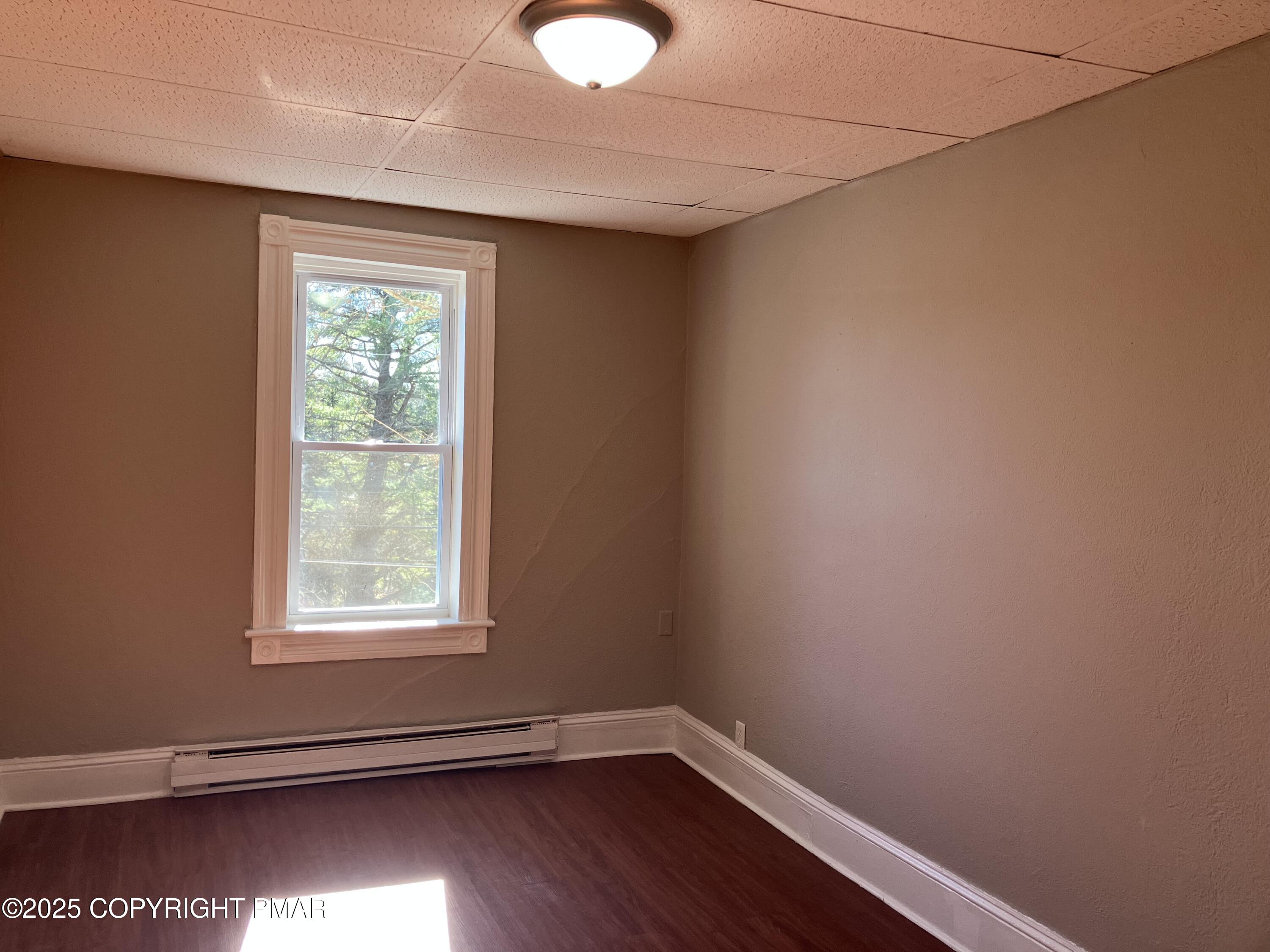 383 Old Rte 940, Unit 301 Pocono Pines, PA 18350 - Photo 8 of 10 an empty room with wooden floor and windows