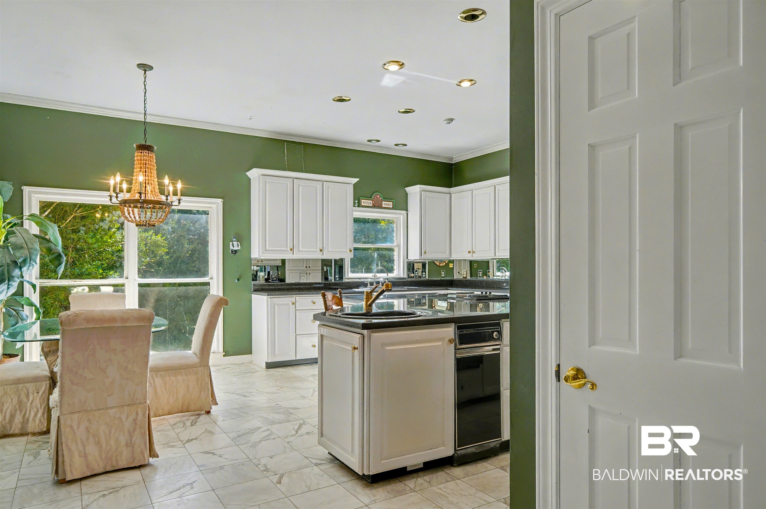 15810 County Road 73 Foley, AL 36535 - Photo 17 of 56 Kitchen featuring white cabinets, dark countertops, a chandelier, light marble finish floors, and pendant lighting