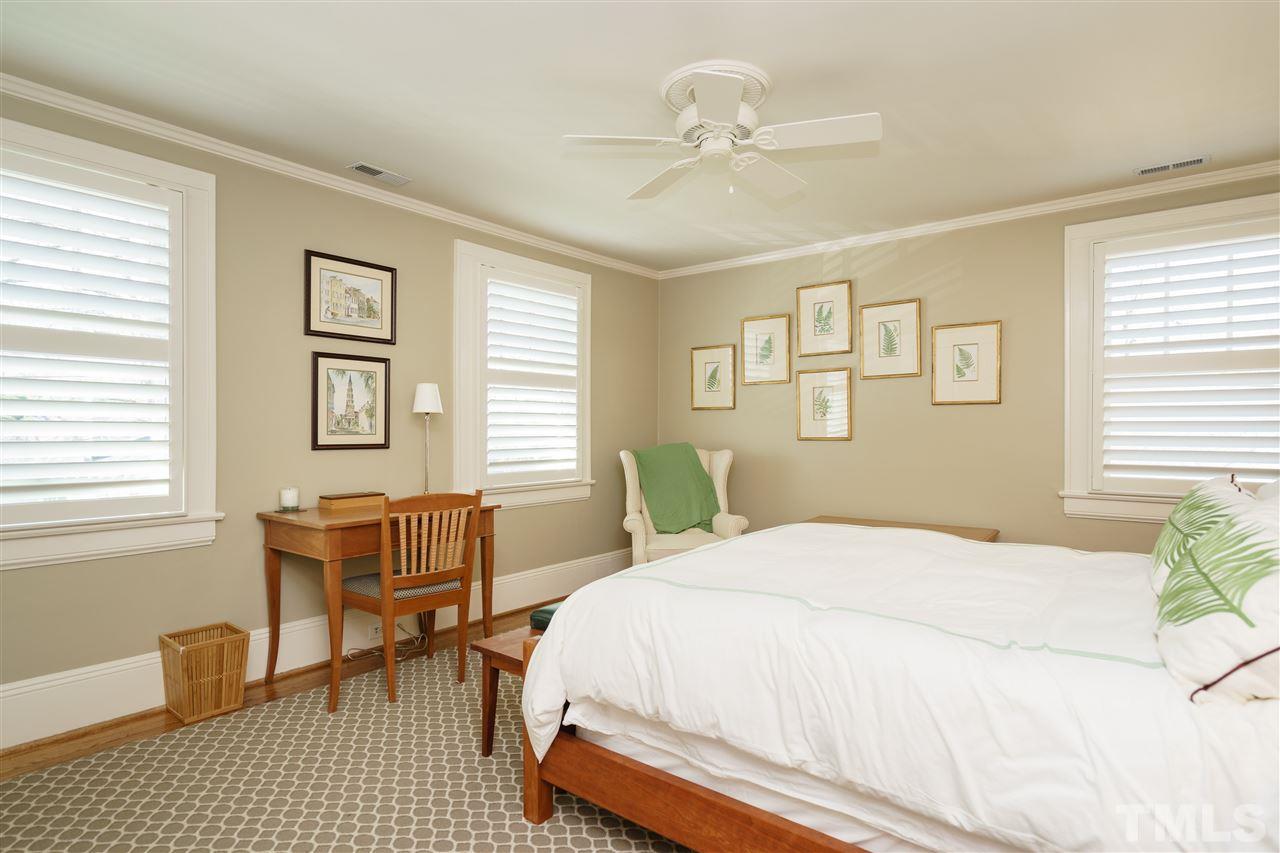 2505 Beechridge Road Raleigh, NC 27608 - Photo 22 of 25 a bedroom with a bed and a table chair