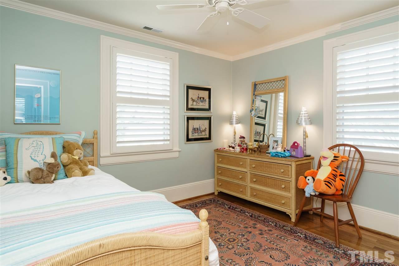 2505 Beechridge Road Raleigh, NC 27608 - Photo 23 of 25 a bed room with a bed and a chair