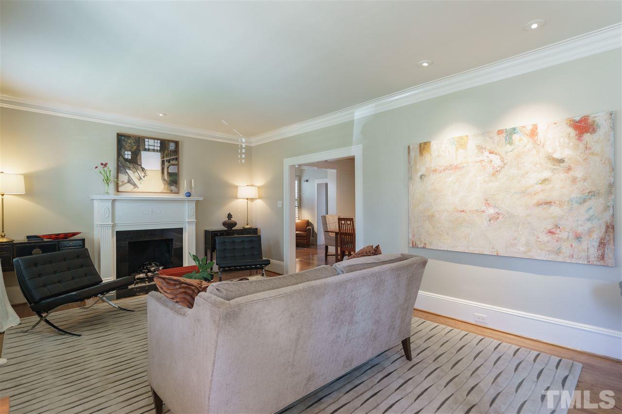 2505 Beechridge Road Raleigh, NC 27608 - Photo 4 of 25 a living room with furniture mirror and a fireplace