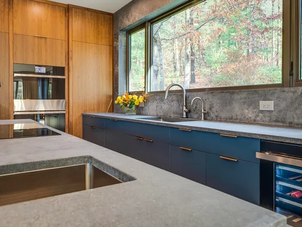 a kitchen with a sink and large window