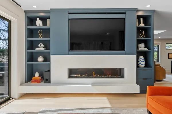 a living room with furniture and a fireplace