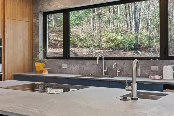 a kitchen with a sink and large window