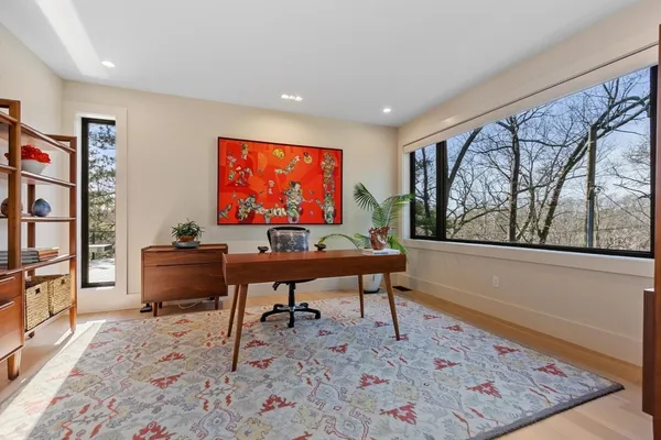 a living room with furniture a rug and a large window