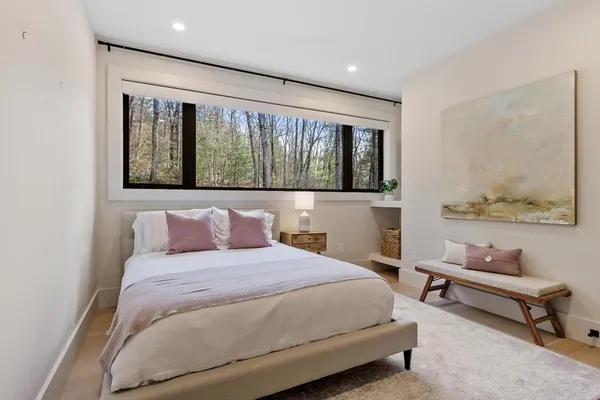 a bedroom with a large bed and a window