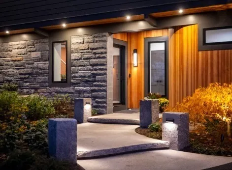 a front view of a house with outdoor seating and plants