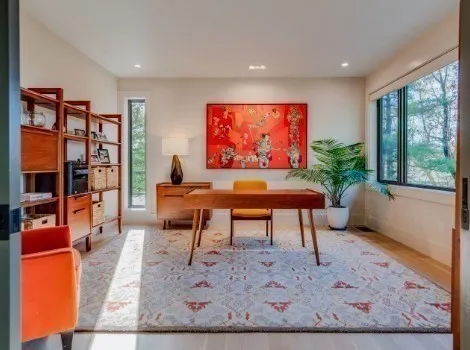a living room with furniture a rug and a large window