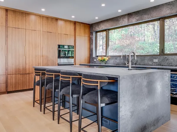 a dining table chair next to a window