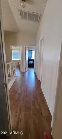 a view of gallery with wooden floor