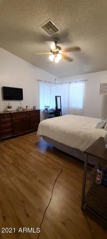 a bedroom with a bed and a dresser