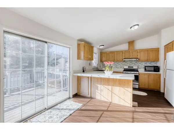 a kitchen with stainless steel appliances granite countertop a stove a sink and a white cabinets