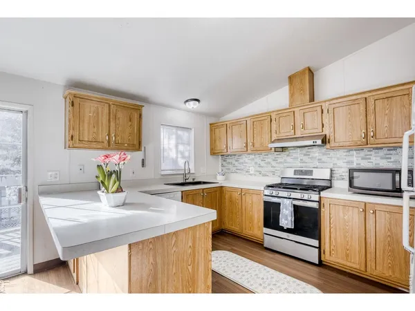 a kitchen with sink cabinets and window
