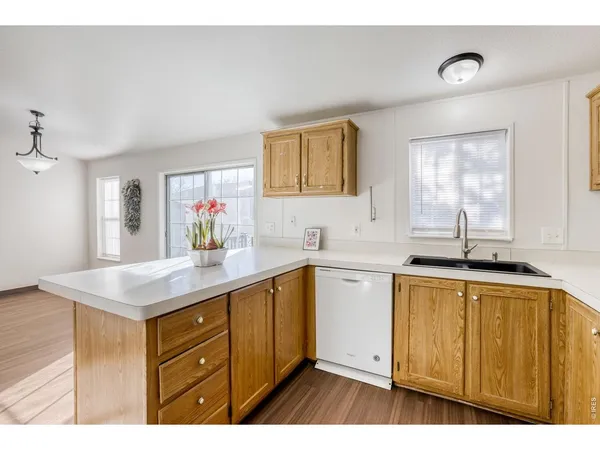 a kitchen with stainless steel appliances granite countertop a refrigerator stove a sink and dishwasher