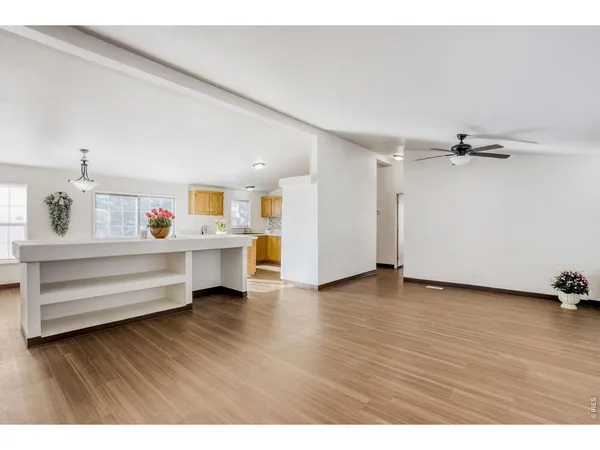 a bedroom with wooden floor and two beds