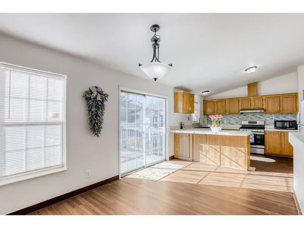 a kitchen with cabinets and outdoor view